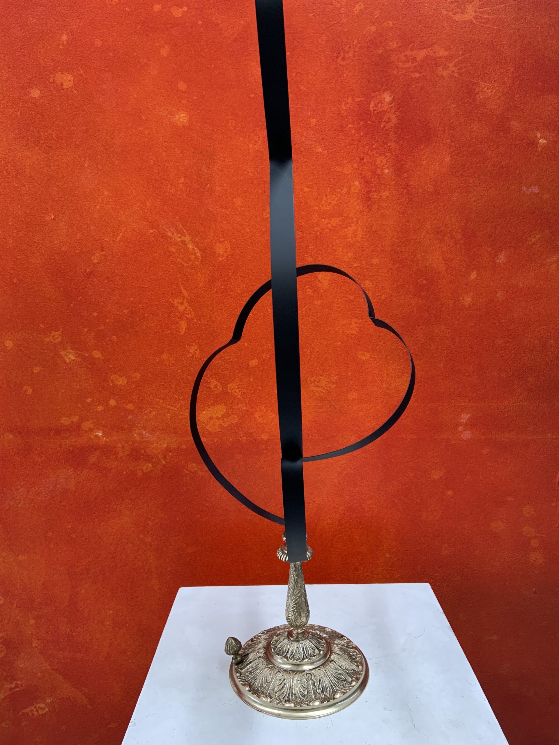 Bird sculpture made from black spring steel strips coiled over a silver-toned base