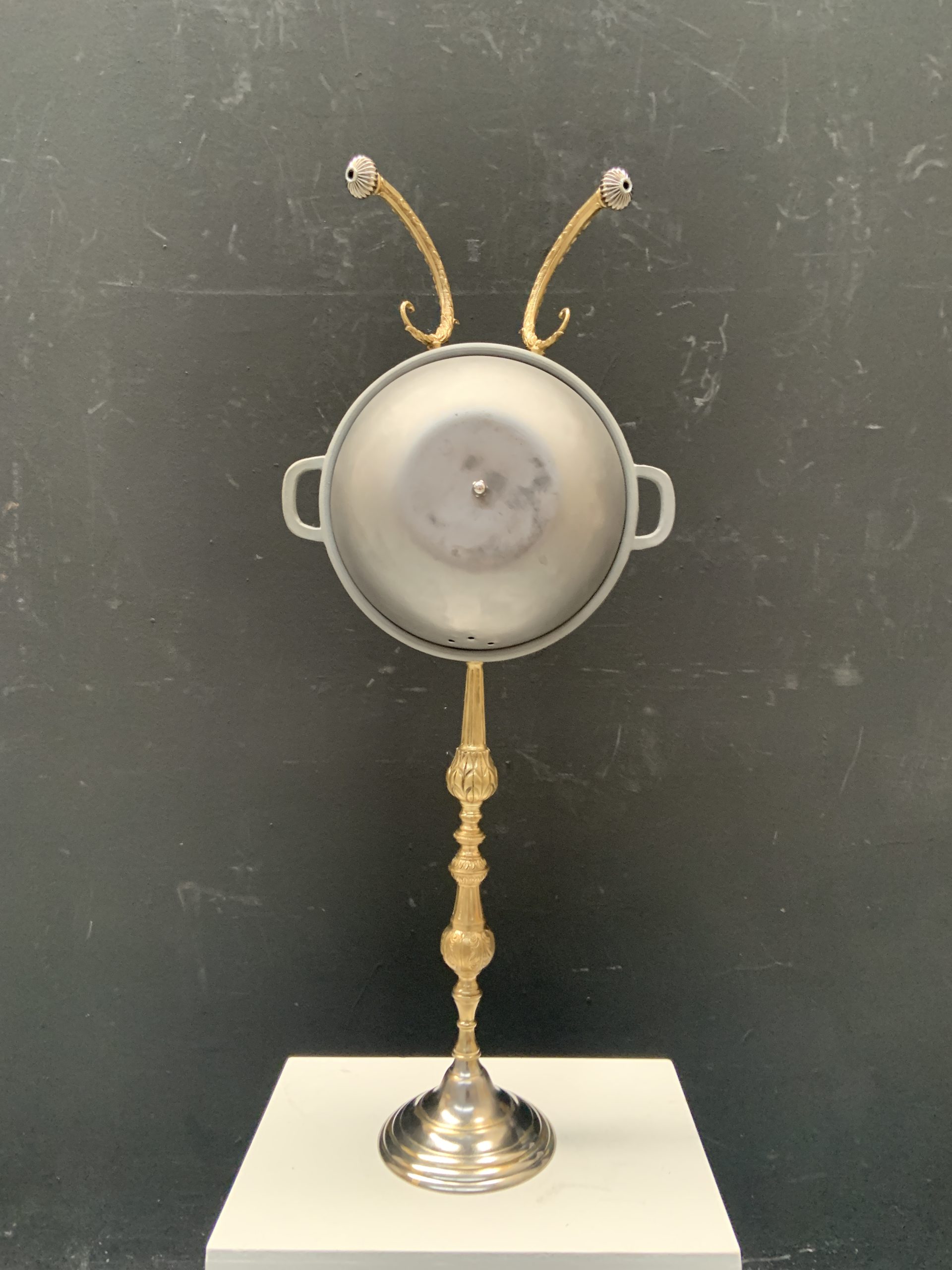 Faun figure made from a saucepan with taps for eyes, on a lamp base - Carrera